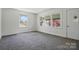 Bright living room features large windows, neutral carpet, and ample natural light at 140 Oak Ave, Mount Holly, NC 28120