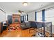 Spacious living room featuring a brick fireplace, ceiling fan, and hardwood floors at 140 Oak Ave, Mount Holly, NC 28120