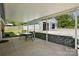 Covered patio with a dining table and view of the detached garage at 140 Oak Ave, Mount Holly, NC 28120