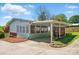 Back of home featuring a covered patio, sunroom, and nicely maintained lawn at 140 Oak Ave, Mount Holly, NC 28120