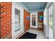 Enclosed sunroom with brick accents, tile floor, and access to the main house at 140 Oak Ave, Mount Holly, NC 28120
