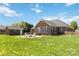 Brick home features a spacious backyard with a fire pit and detached garage at 15118 Marshall Valley Ct, Mint Hill, NC 28227