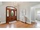 Bright foyer with hardwood floors, decorative lighting, and an ornate wooden front door at 15118 Marshall Valley Ct, Mint Hill, NC 28227