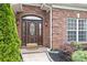 Close up of the front door with decorative glass and sidelights at 15118 Marshall Valley Ct, Mint Hill, NC 28227