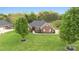 Charming brick home with lush front lawn and manicured landscaping and mature trees at 15118 Marshall Valley Ct, Mint Hill, NC 28227