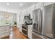 This kitchen features stainless steel appliances, quartz countertops, a breakfast nook, and stylish pendant lighting at 15118 Marshall Valley Ct, Mint Hill, NC 28227