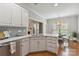 Modern kitchen featuring white cabinets, stainless steel appliances, and hardwood floors at 15118 Marshall Valley Ct, Mint Hill, NC 28227