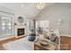 Cozy living room featuring a fireplace, modern decor, and lots of natural light at 15118 Marshall Valley Ct, Mint Hill, NC 28227