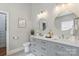 A luxurious main bathroom with double vanity sinks, elegant mirrors, and modern fixtures at 15118 Marshall Valley Ct, Mint Hill, NC 28227