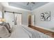 A bright main bedroom featuring a tray ceiling, hardwood floors, and access to the main bathroom at 15118 Marshall Valley Ct, Mint Hill, NC 28227