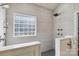 The elegant walk-in shower is equipped with rain shower heads and high-end tile at 15118 Marshall Valley Ct, Mint Hill, NC 28227