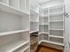 Large walk-in closet with custom shelving, multiple storage options, and hardwood floors at 15118 Marshall Valley Ct, Mint Hill, NC 28227