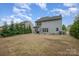 Backyard featuring a patio, evergreen trees, and ample space for outdoor activities at 15324 Colonial Park Dr, Huntersville, NC 28078