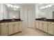 Bathroom featuring dual sinks with granite countertop, mirrors, and tile floors at 15324 Colonial Park Dr, Huntersville, NC 28078