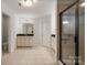 Spacious bathroom featuring double vanities, tile floors, and a glass-enclosed shower at 15324 Colonial Park Dr, Huntersville, NC 28078