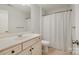 Neutral bathroom with a single vanity and shower featuring a white curtain at 15324 Colonial Park Dr, Huntersville, NC 28078