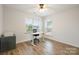 Bright bedroom with two windows, wood flooring, and a ceiling fan at 15324 Colonial Park Dr, Huntersville, NC 28078