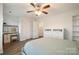 Bedroom featuring a bed, wood floors, and a vanity with a stool and mirror at 15324 Colonial Park Dr, Huntersville, NC 28078