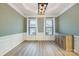 Elegant dining room featuring modern lighting, wainscoting, and ample natural light at 15324 Colonial Park Dr, Huntersville, NC 28078