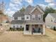 Charming two-story home with stone accents, a welcoming front porch, and a well-maintained lawn at 15324 Colonial Park Dr, Huntersville, NC 28078
