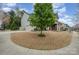Landscaped front yard with mature tree, garage and lovely curb appeal at 15324 Colonial Park Dr, Huntersville, NC 28078