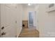 Hallway with wood floors and multiple doors at 15324 Colonial Park Dr, Huntersville, NC 28078