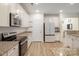 Modern kitchen with granite countertops, stainless steel appliances, and white cabinets at 15324 Colonial Park Dr, Huntersville, NC 28078