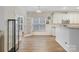 Bright kitchen features stainless steel appliances, granite countertops, and french doors at 15324 Colonial Park Dr, Huntersville, NC 28078