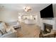 Spacious living room with a cozy fireplace, open kitchen, and comfortable sectional couch at 15324 Colonial Park Dr, Huntersville, NC 28078