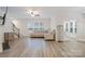 Bright living room with a cozy couch, neutral colors, and hardwood floors at 15324 Colonial Park Dr, Huntersville, NC 28078
