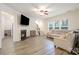 Bright living room featuring a fireplace, hardwood floors, a cozy couch, and a neutral color palette at 15324 Colonial Park Dr, Huntersville, NC 28078