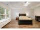 Main bedroom with a tray ceiling, ceiling fan, and two windows at 15324 Colonial Park Dr, Huntersville, NC 28078