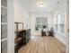 Bright sun room with lots of windows, modern shelving, and hardwood floors at 15324 Colonial Park Dr, Huntersville, NC 28078