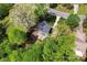 Aerial view of a home with a stone fireplace, backyard patio and mature landscaping at 1536 Bear Mountain Rd, Charlotte, NC 28214