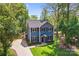 Aerial view of a beautiful two-story home with mature landscaping, long driveway and fenced yard at 1536 Bear Mountain Rd, Charlotte, NC 28214