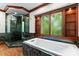 A luxurious bathroom featuring a separate shower and soaking tub with beautiful tile and a bright window at 1536 Bear Mountain Rd, Charlotte, NC 28214