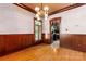 Formal dining room with hardwood floors, wainscoting, and chandelier lighting at 1536 Bear Mountain Rd, Charlotte, NC 28214