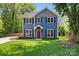 Charming two-story home with blue siding, brown shutters, and a well-manicured lawn at 1536 Bear Mountain Rd, Charlotte, NC 28214