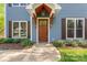 Beautiful Craftsman-style front door with decorative windows and covered porch at 1536 Bear Mountain Rd, Charlotte, NC 28214