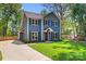 Beautiful two-story home with blue siding, a well-manicured lawn, and a private driveway at 1536 Bear Mountain Rd, Charlotte, NC 28214