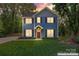 Inviting home with warm lighting and a lush front lawn, perfect for evening strolls at 1536 Bear Mountain Rd, Charlotte, NC 28214
