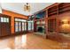Stylish Gathering room featuring built-in shelves, a brick fireplace, and hardwood floors at 1536 Bear Mountain Rd, Charlotte, NC 28214