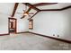 Spacious main bedroom featuring wood beam accents, neutral carpet, ceiling fan, and attached bathroom at 1536 Bear Mountain Rd, Charlotte, NC 28214