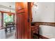 Stylish powder room featuring custom wood vanity with hammered metal sink, adjacent to a dining room at 1536 Bear Mountain Rd, Charlotte, NC 28214