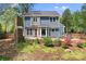 Charming home featuring a stone fireplace, patio, manicured lawn and fenced yard at 1536 Bear Mountain Rd, Charlotte, NC 28214