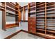 Walk-in closet featuring custom wooden shelving and cabinetry providing ample storage space at 1536 Bear Mountain Rd, Charlotte, NC 28214