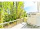 View from wooden back deck with rail overlooking yard and treeline, with a partial view of neighboring properties at 162 Limerick Rd # C, Mooresville, NC 28115