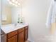 Bathroom with light counters and vanity, wood cabinets, and decorative touches at 162 Limerick Rd # C, Mooresville, NC 28115
