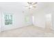 A spacious bedroom featuring carpet, natural light from windows, and a ceiling fan at 162 Limerick Rd # C, Mooresville, NC 28115