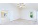 Bright bedroom features a ceiling fan, neutral paint, carpet flooring, and natural light from a window at 162 Limerick Rd # C, Mooresville, NC 28115